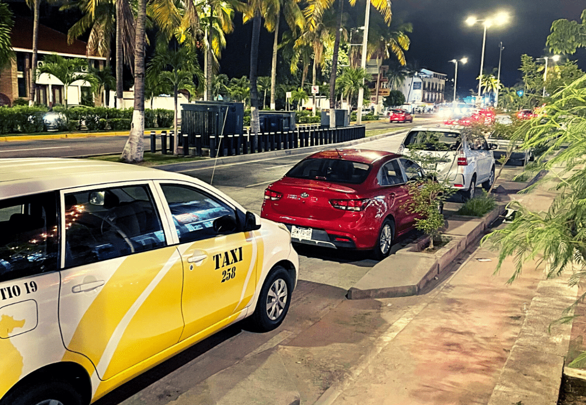 A taxi waiting outside of a restaurant in Puerto Vallarta.