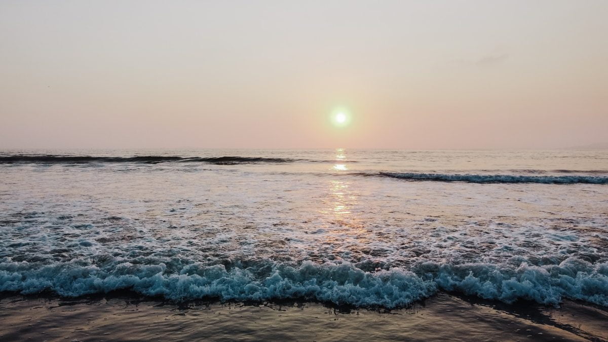 ocean waves crashing on shore during sunset in Ensenada hotel